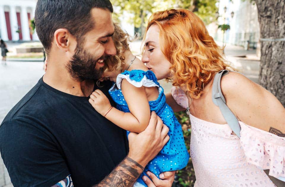Father Child and Mother kissing Father Child and Mother kissing