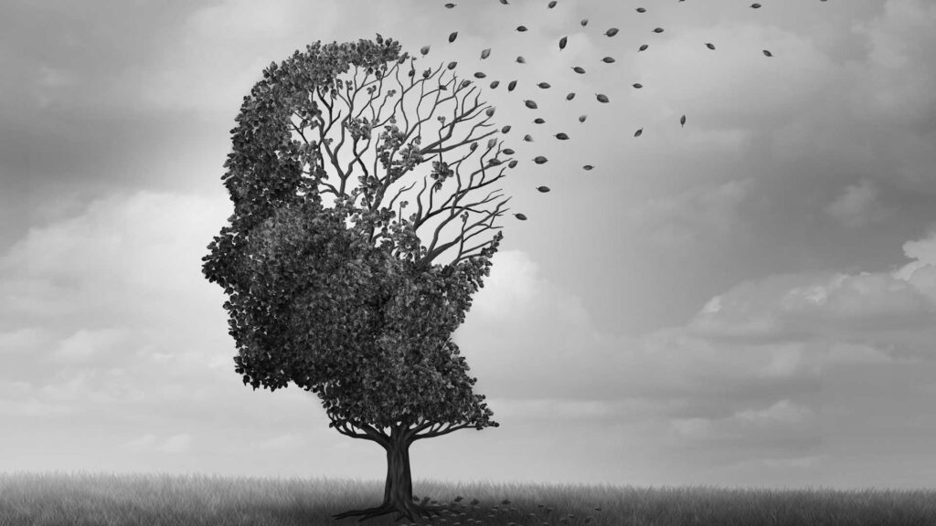 A tree in the shape of a human head with leaves blowing in the wind to signify schizophrenia and drug use.