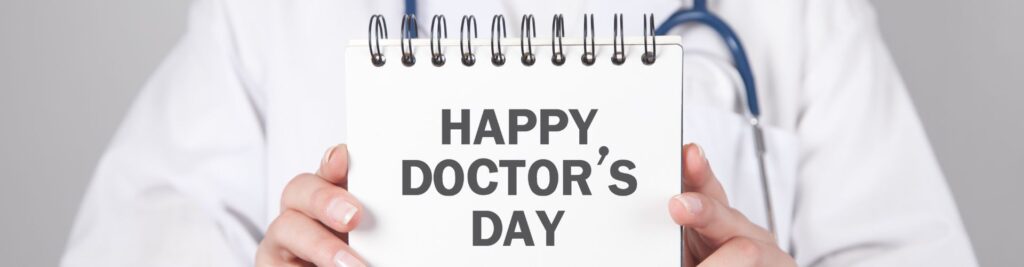 National Doctors Day. A doctor holds a sign saying "Happy Doctor's Day"