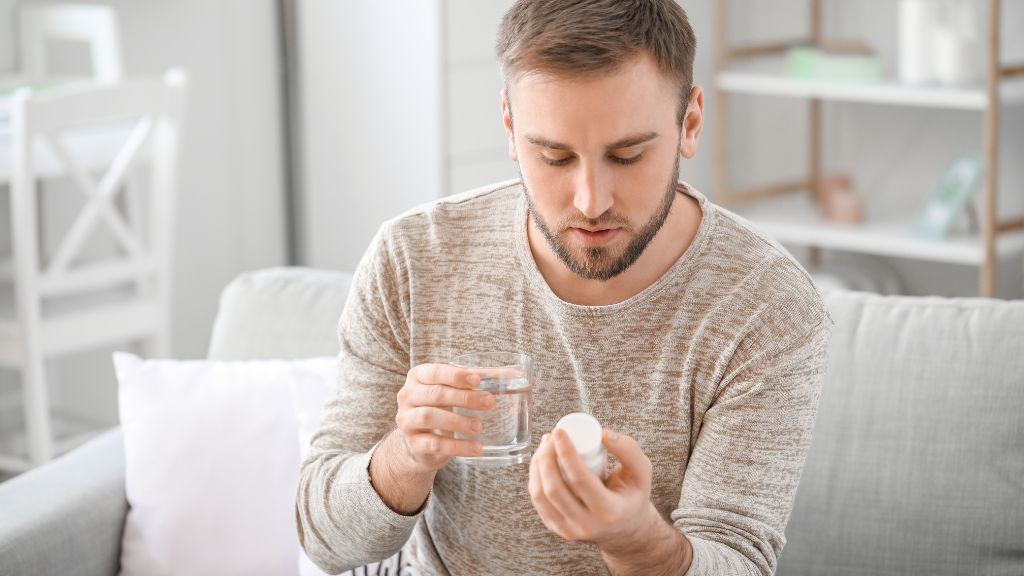 Man reading what is ketamine medication bottle before taking medication