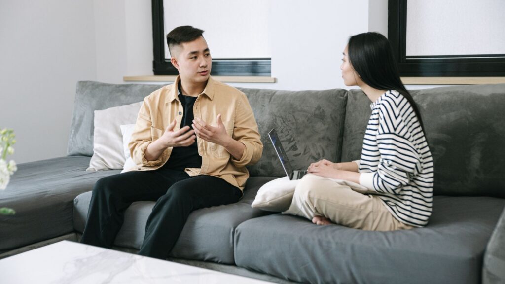 Two people discussing addiction treatment options on how to get someone into rehab