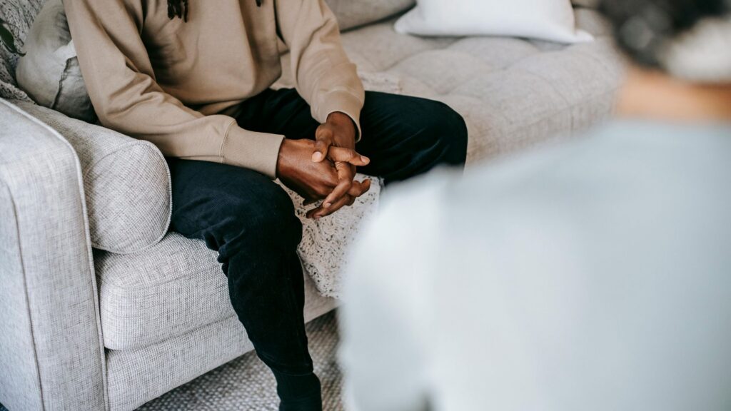 Person speaking with a professional about addiction treatment