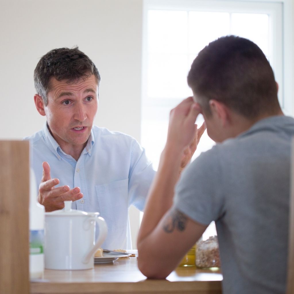Two men having a serious conversation about how to get someone into rehab